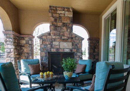 back porch outdoor fireplace made out of stone