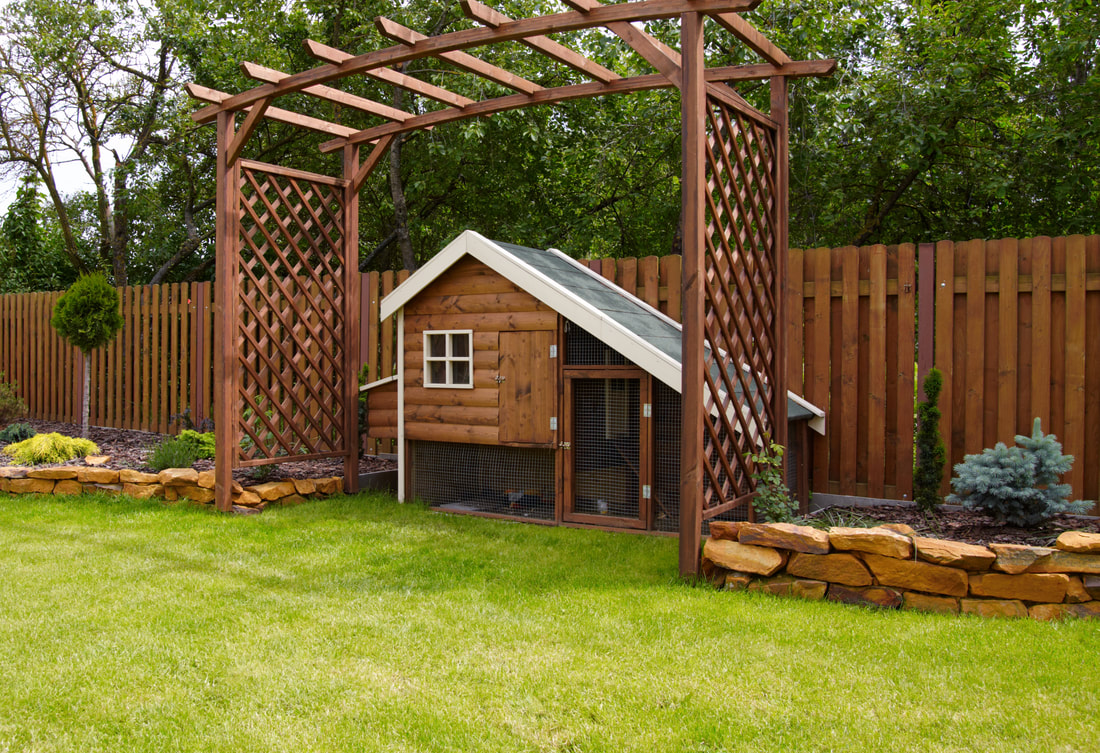 stone masonry with wooden trestle over chicken coop outdoor living