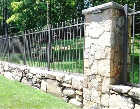 wrought iron fence with short stone masonry wall