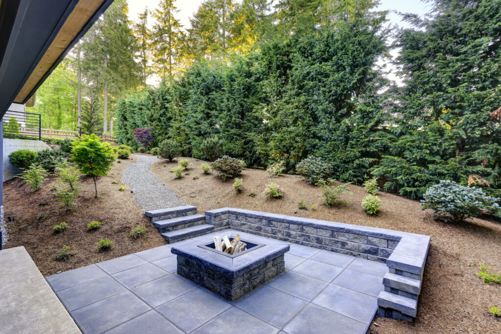 New modern home features a backyard with fire pit