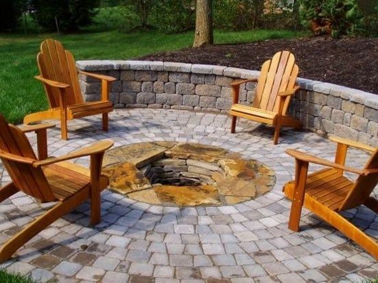 residential sunken sire surrounded by stone masonry in backyard